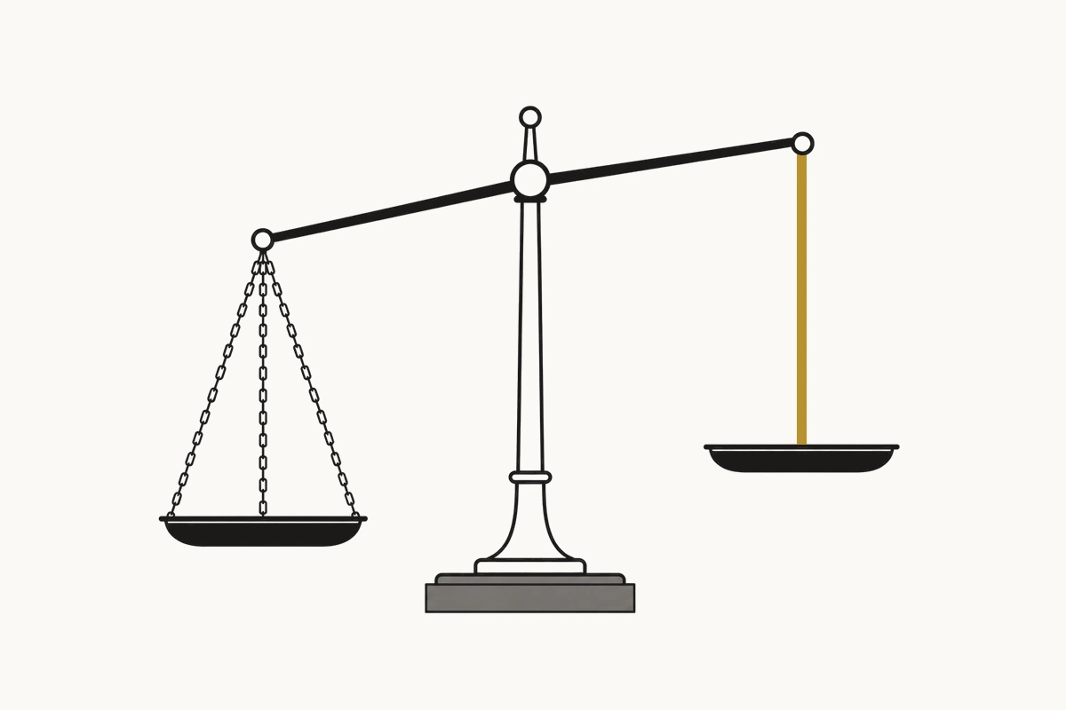 A balance scale with one pan hanging from chains and the other fixed rigidly to the beam.