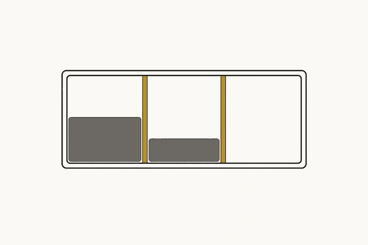 A specimen tray divided into three compartments by two brass dividers, the left two holding different amounts and the right empty.
